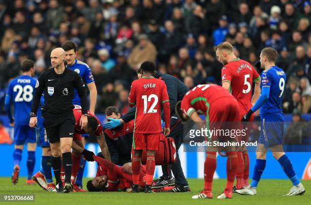 Leroy Fer of Swansea City goes down injured and is seen by medics during the Premier League match between Leicester City and Swansea City at The King...