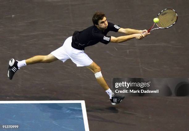 Gilles Simon of France plays a backhand in his match against Jurgen Melzer of Austria during day eight of the 2009 Thailand Open at Impact Arena on...