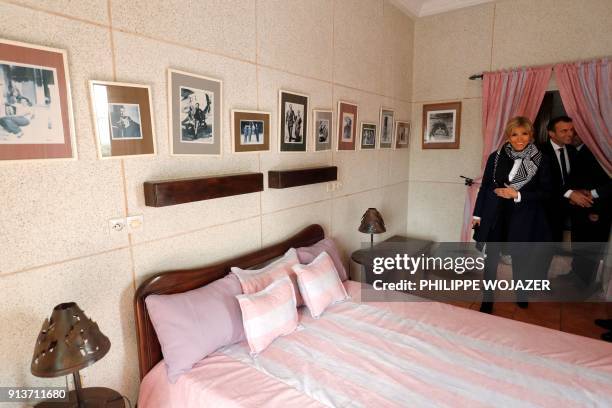 French President Emmanuel Macron and his wife Brigitte Macron visit the room where aviator Jean Mermoz stayed at the Hotel de la Poste in Saint...