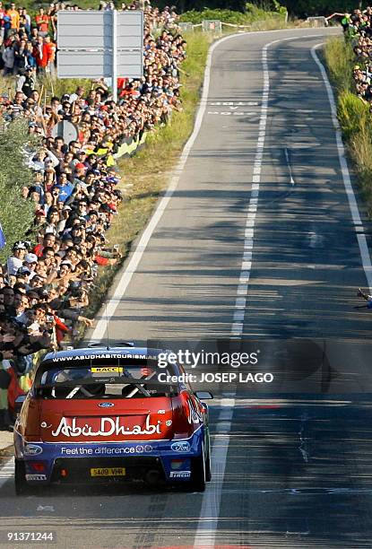 Finland's Mikko Hirvonen and Co-Driver Jarmo Lehtinen drive their Ford Focus during the second stage of the 45th Rally of Catalonia in El Molar near...