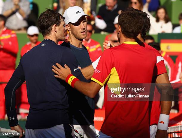 Pablo Carreno Busta and Feliciano Lopez of Spain are congratulated by Dom Inglot and Jamie Murray of Great Britain after their straight sets win in...