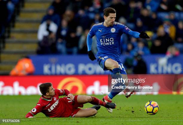 Tom Carroll of Swansea City tackles Adrien Silva of Leicester City during the Premier League match between Leicester City and Swansea City at The...