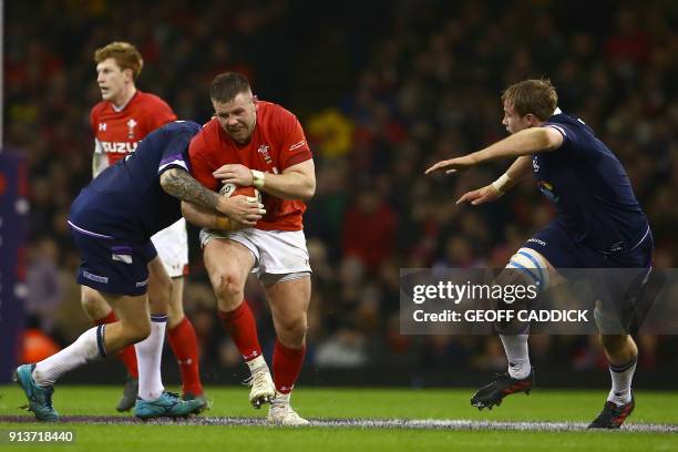 Wales' prop Rob Evans is tackled during the Six Nations international rugby union match between Wales and Scotland at the Principality Stadium in...