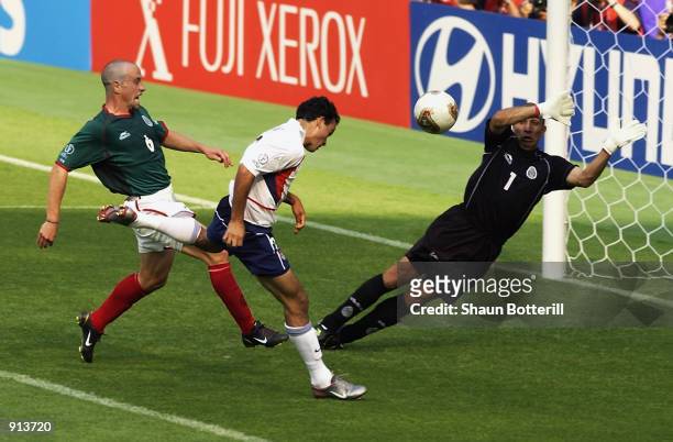Landon Donovan of the USA beats Gerardo Torrado and Oscar Perez of Mexico to score the second goal during the Mexico v USA, World Cup Second Round...