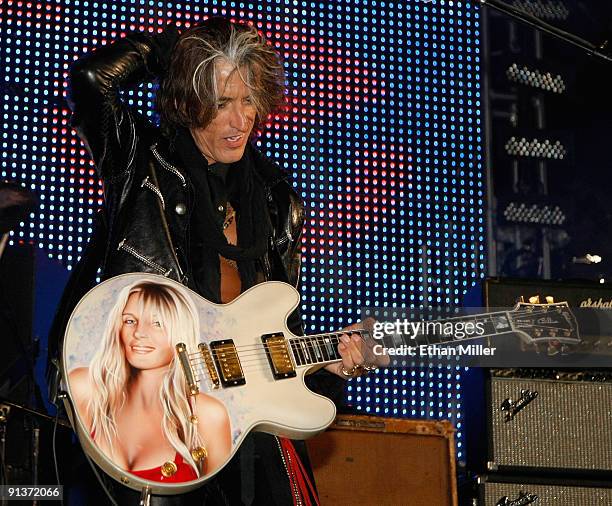 Aerosmith guitarist Joe Perry plays a Gibson guitar with an image of his wife Billie Perry on it as he performs during a concert at the Bare Pool...