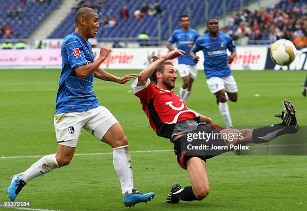 Du-Ri Cha of Freiburg and Christian Schulz of Hannover battle for the ball during the Bundesliga match between Hannover 96 and SC Freiburg at...