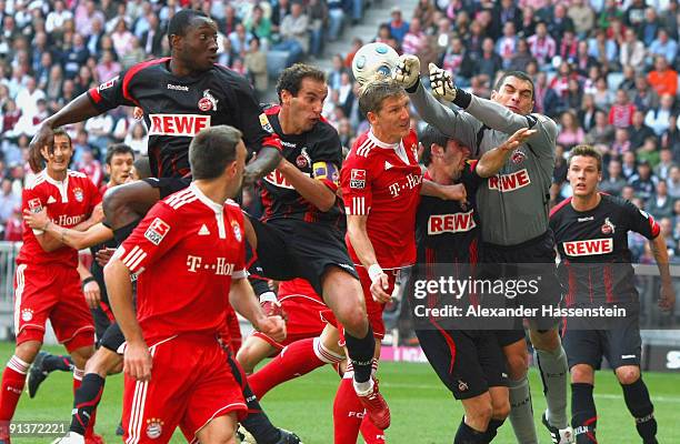 Bastian Schweinsteiger of Muenchen battles for the ball with Faryd Mondragon keeper of Koeln during the Bundesliga match between FC Bayern Muenchen...