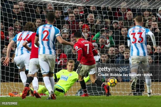 Alexis Sanchez of Manchester United scores a goal to make it 2-0 during the Premier League match between Manchester United and Huddersfield Town at...