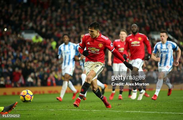 Alexis Sanchez of Manchester United scores his sides second goal during the Premier League match between Manchester United and Huddersfield Town at...