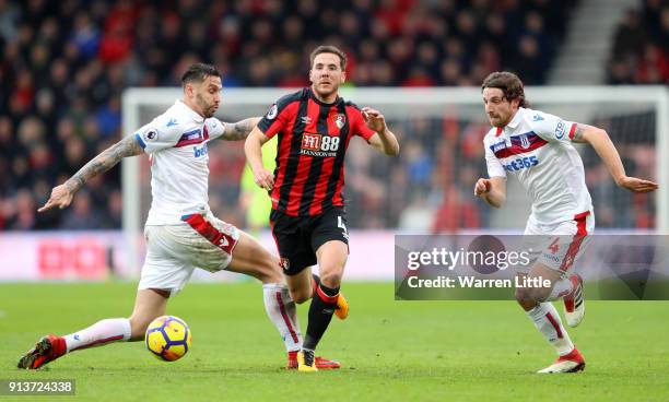 Dan Gosling of AFC Bournemouth escapes a challenge from Geoff Cameron of Stoke City during the Premier League match between AFC Bournemouth and Stoke...