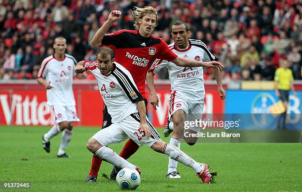 Stefan Kiessling of Leverkusen is challenged by Javier Pinola and Jawhar Mnari of Nuernberg during the Bundesliga match between Bayer Leverkusen and...