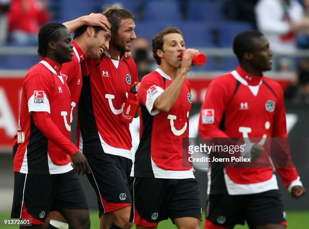 Karim Haggui of Hannover celebrates with his team mates after scoring his team's third goal during the Bundesliga match between Hannover 96 and SC...