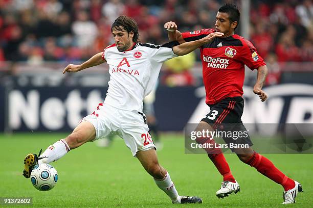 Thomas Broich of Nuernberg is challenged by Arturo Vidal of Leverkusen during the Bundesliga match between Bayer Leverkusen and 1. FC Nuernberg at...