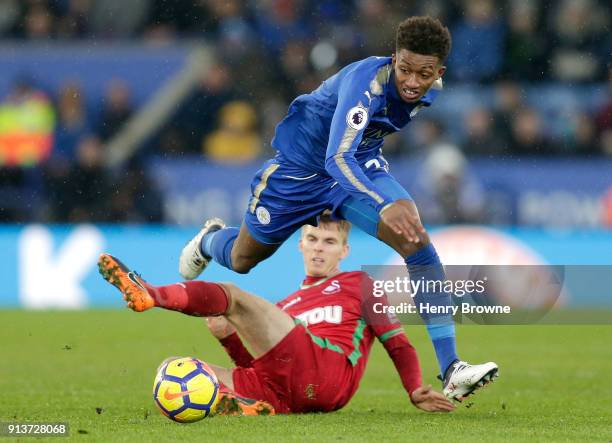 Demarai Gray of Leicester City is tackled by Tom Carroll of Swansea City during the Premier League match between Leicester City and Swansea City at...