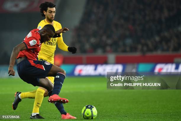 Lille's French midefielder Ibrahim Amadou vies for the ball with Paris Saint-Germain's Argentinian midfielder Javier Pastore during French L1...