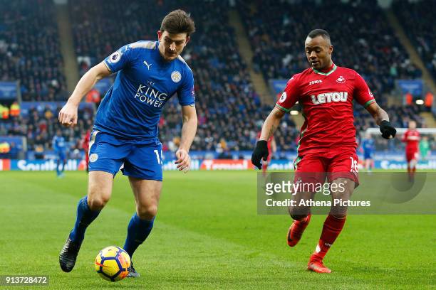 Harry Maguire of Leicester City contends with Jordan Ayew of Swansea during the Premier League match between Leicester City and Swansea City at the...