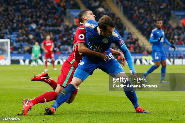 Kyle Naughton of Swansea is challenged by Christian Fuchs of Leicester City during the Premier League match between Leicester City and Swansea City...