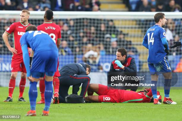 Leroy Fer of Swansea holds his ankle after falling to the ground during the Premier League match between Leicester City and Swansea City at the...