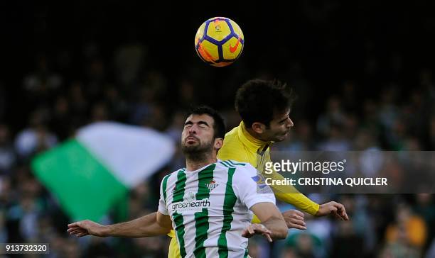 Villarreal's Spanish midfielder Manuel Trigueros Munoz jumps for the ball with Real Betis' Spanish defender Jordi Amat during the Spanish league...