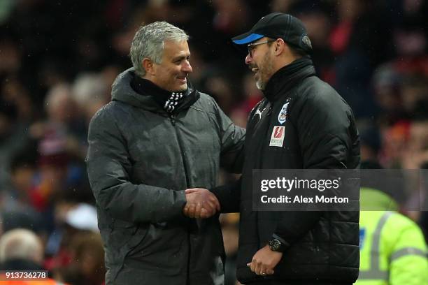 Jose Mourinho, Manager of Manchester United and David Wagner, Manager of Huddersfield Town embrace after the Premier League match between Manchester...