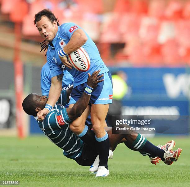 Trompie Nontshinga of GWK Griquas tackles Francois Hougaard of the Bulls during the Absa Currie Cup match between Blue Bulls and GWK Griquas at...