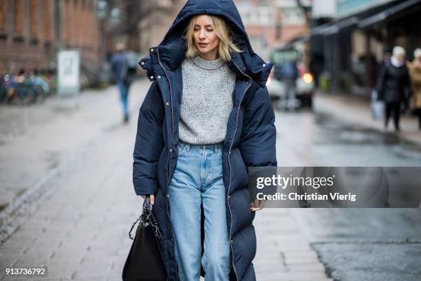 Lisa Hahnbueck wearing navy Tommy Hilfiger x Gigi Hadid down feather jacket coat, Victoria Beckham knit, Goldsign denim jeans, Mai Piu Senza velvet...