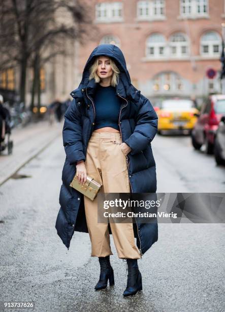 Lisa Hahnbueck wearing navy Tommy Hilfiger x Gigi Hadid down feather jacket, coat, Alexander Wang cropped top, beige I Am Gia cropped wide leg pants,...