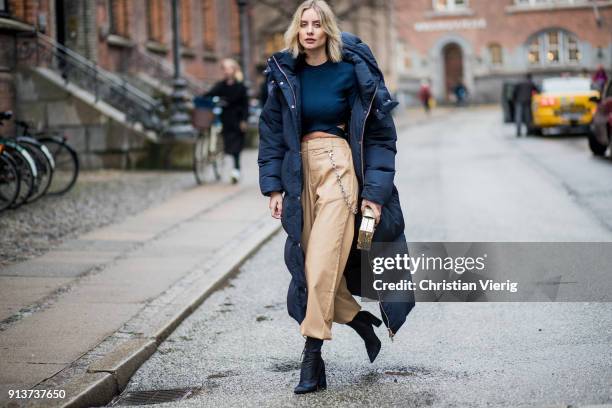 Lisa Hahnbueck wearing navy Tommy Hilfiger x Gigi Hadid down feather jacket, coat, Alexander Wang cropped top, beige I Am Gia cropped wide leg pants,...