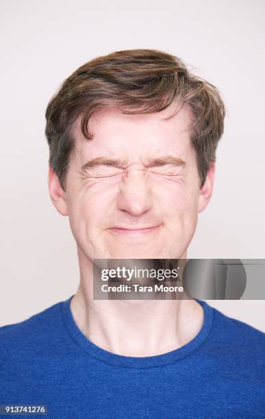 man with eyes closed tightly shut - man smiling eyes closed stock pictures, royalty-free photos & images