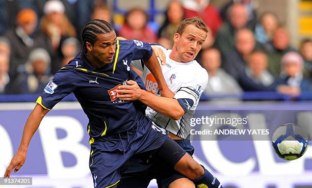 Bolton Wanderers English forward Kevin Davies vies with Tottenham Hotspur's French-Cameroonian defender Benoit Assou Ekotto during the English...