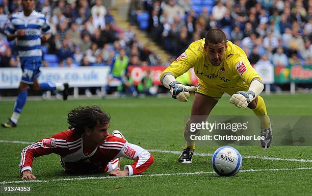 Adam Federici of Reading dives on the ball to stop Jeremie Aliadiere of Middlesbrough during the Coca-Cola Championship match between Reading and...