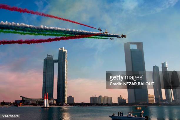 The United Arab Emirates' Al-Fursan National Aerobatic Team performs with smoke with the colours of the UAE flag, during the 2018 Red Bull Air Race...