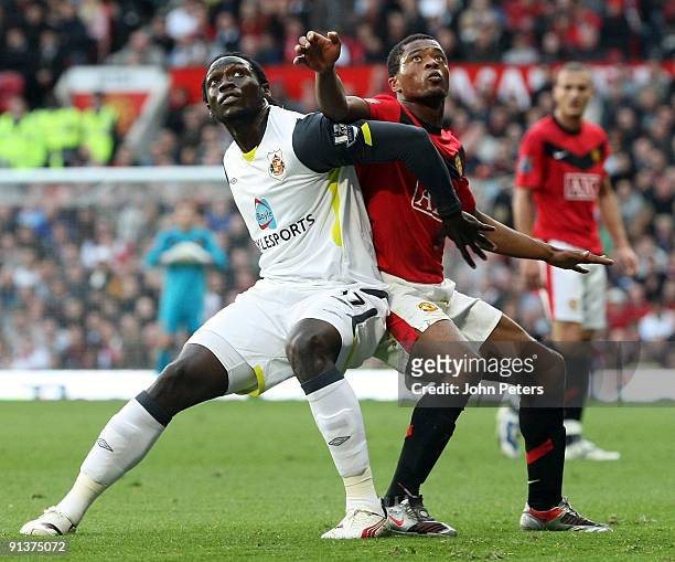 Patrice Evra of Manchester United clashes with Kenwyne Jones of Sunderland during the FA Barclays Premier League match between Manchester United and...