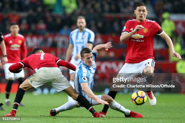 Alexis Sanchez of Man Utd tackles Jonathan Hogg of Huddersfield to leave the ball open for Nemanja Matic of Man Utd during the Premier League match...