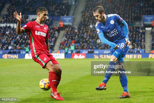 Kyle Naughton of Swansea challenges Christian Fuchs of Leicester City during the Premier League match between Leicester City and Swansea City at the...