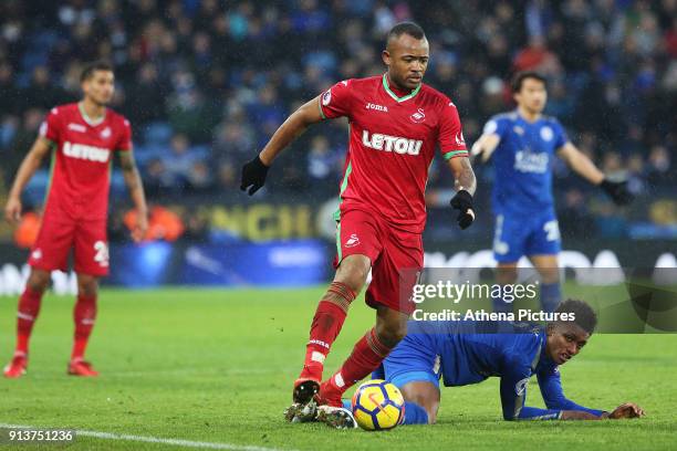 Jordan Ayew of Swansea wins possession from Demarai Gray of Leicester City during the Premier League match between Leicester City and Swansea City at...