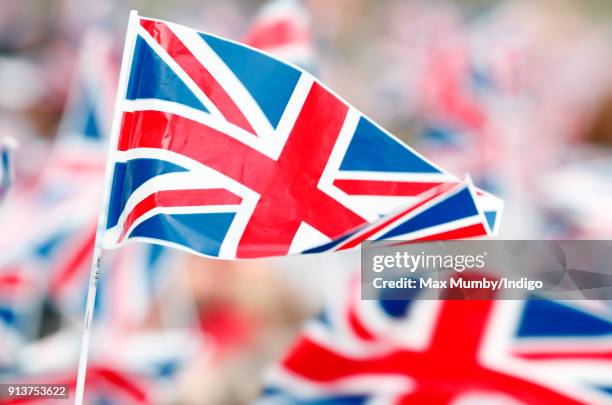 Children wave Union Flags ahead of a visit by Catherine, Duchess of Cambridge to The Wimbledon Junior Tennis Initiative at Bond Primary School on...