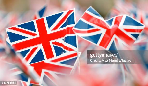 Children wave Union Flags ahead of a visit by Catherine, Duchess of Cambridge to The Wimbledon Junior Tennis Initiative at Bond Primary School on...