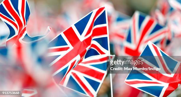 Children wave Union Flags ahead of a visit by Catherine, Duchess of Cambridge to The Wimbledon Junior Tennis Initiative at Bond Primary School on...