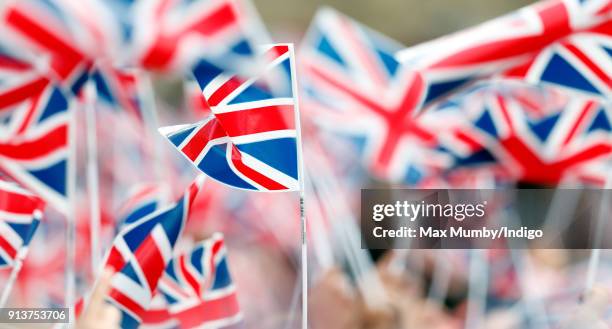 Children wave Union Flags ahead of a visit by Catherine, Duchess of Cambridge to The Wimbledon Junior Tennis Initiative at Bond Primary School on...