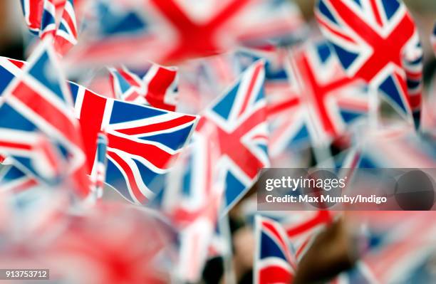 Children wave Union Flags ahead of a visit by Catherine, Duchess of Cambridge to The Wimbledon Junior Tennis Initiative at Bond Primary School on...