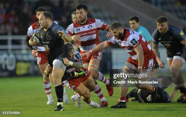 Kyle Cooper of Newcastle Falcons is tackled by Richard Hibbard of Gloucester Rugby during the Anglo-Welsh Cup match between Newcastle Falcons and...