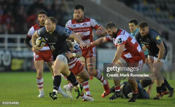 Kyle Cooper of Newcastle Falcons is tackled by Richard Hibbard of Gloucester Rugby during the Anglo-Welsh Cup match between Newcastle Falcons and...