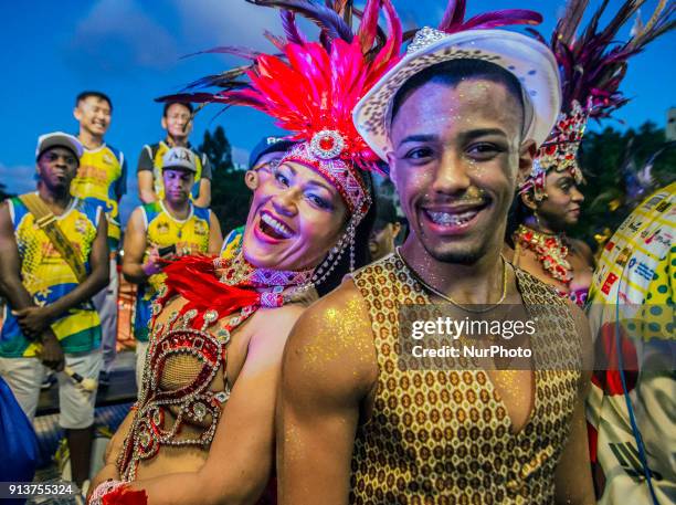 Revelers pose during street Carnival celebrations. Street carnival in Sao Paulo, many groups, called blocos, has bands and thousands of revelers ,...