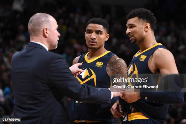 Head Coach Michael Malone talks with players Gary Harris and Jamal Murray of the Denver Nuggets during the game against the Oklahoma City Thunder on...