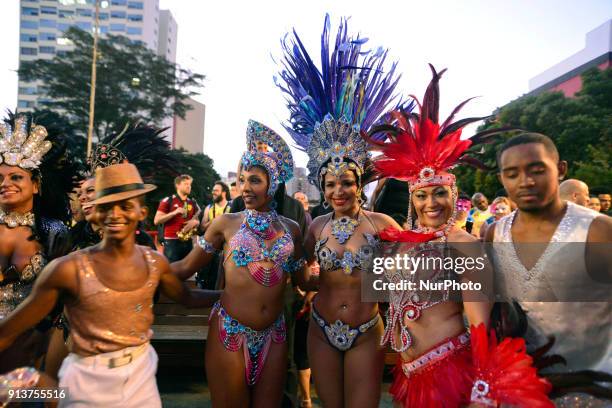 Revelers pose during street Carnival celebrations. Street carnival in Sao Paulo, many groups, called blocos, has bands and thousands of revelers ,...