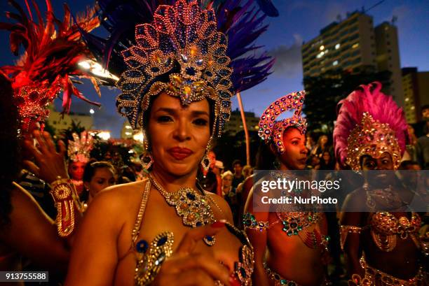 Revelers pose during street Carnival celebrations. Street carnival in Sao Paulo, many groups, called blocos, has bands and thousands of revelers ,...