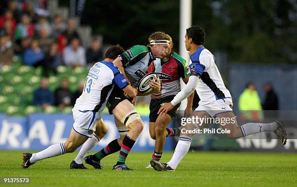 Jim Evans of Harlequins gets tackled by Matt Carraro of Bath during the Guinness Premiership game between Harlequins and Bath at the Stoop on October...