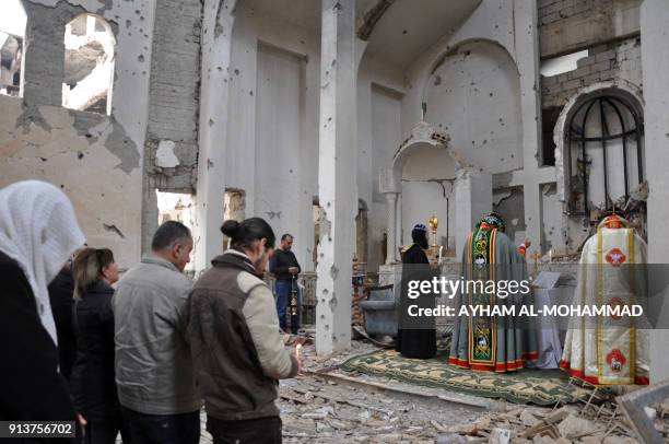 Syriac Orthodox Patriarch of Antioch, Ignatius Aphrem II, holds mass at the heavily damaged Syriac Orthodox church of St. Mary in Syria's eastern...