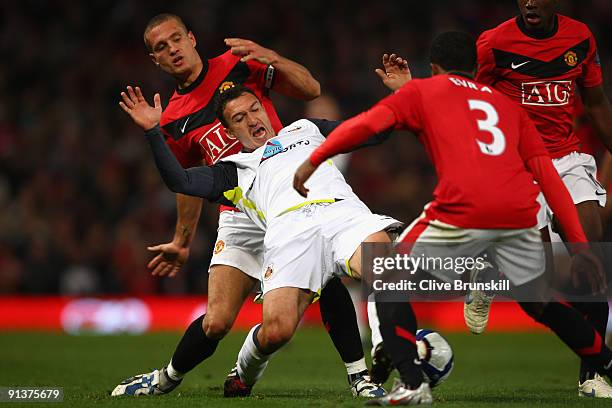 Steed Malbranque of Sunderland is challenged by Nemanja Vidic of Manchester United during the Barclays Premier League match between Manchester United...